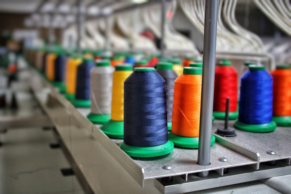 Close-up of colourful sewing thread wound on spools